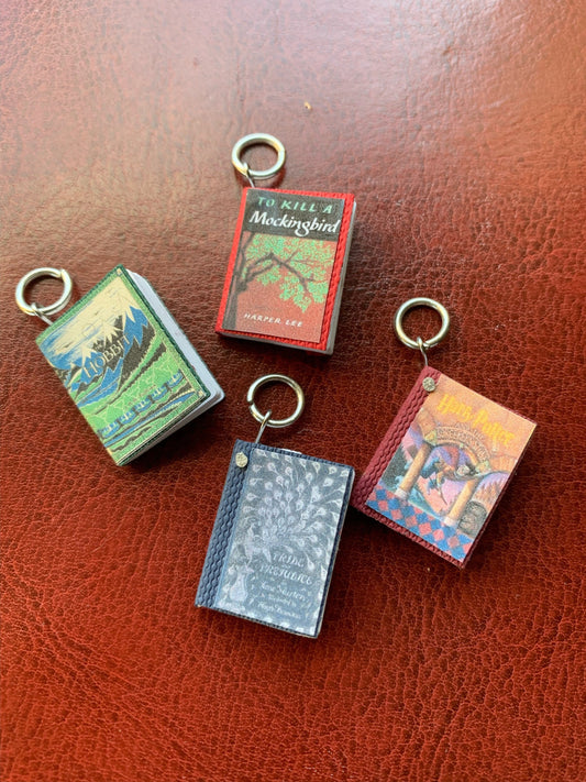 4 different colors of mini book pendants