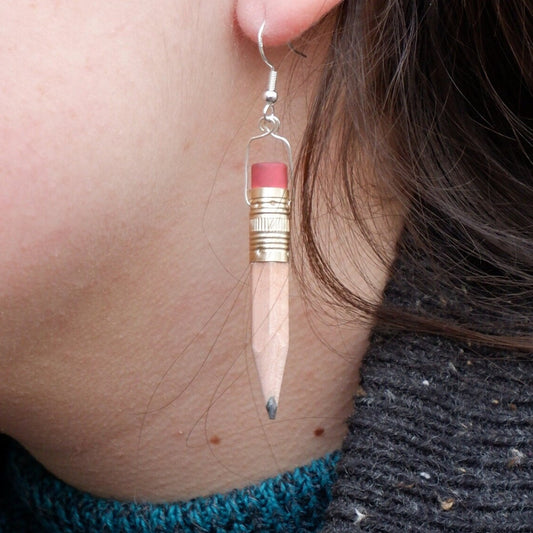 pencil earring with eraser being worn